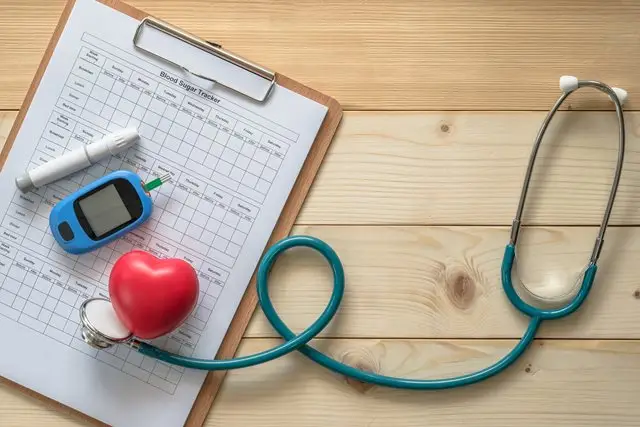 a stethoscope and a heart on a clipboard