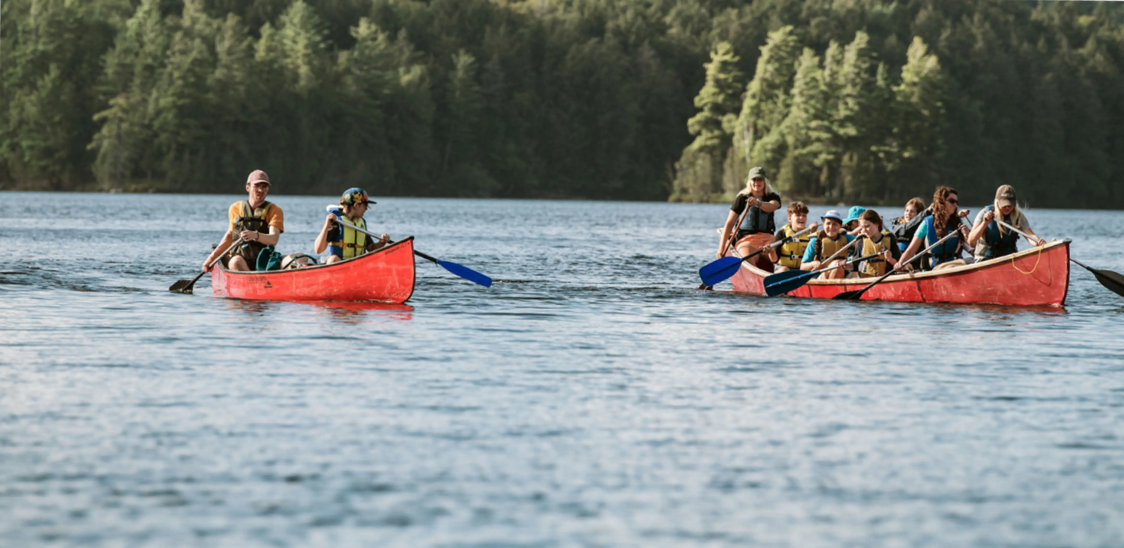 a group of people in canoes on a lake