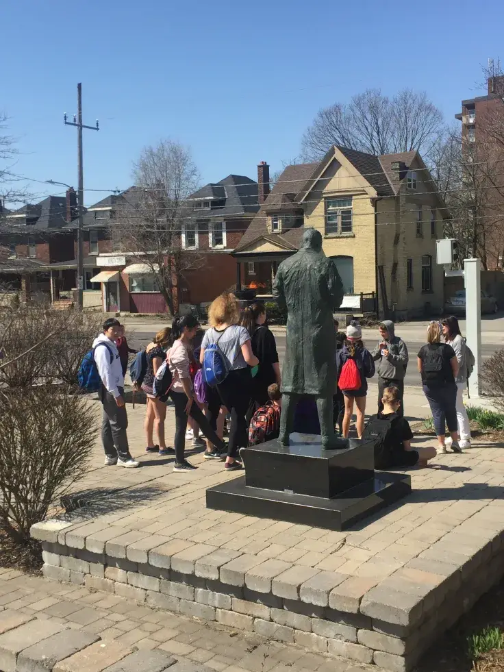 a group of people standing around a statue
