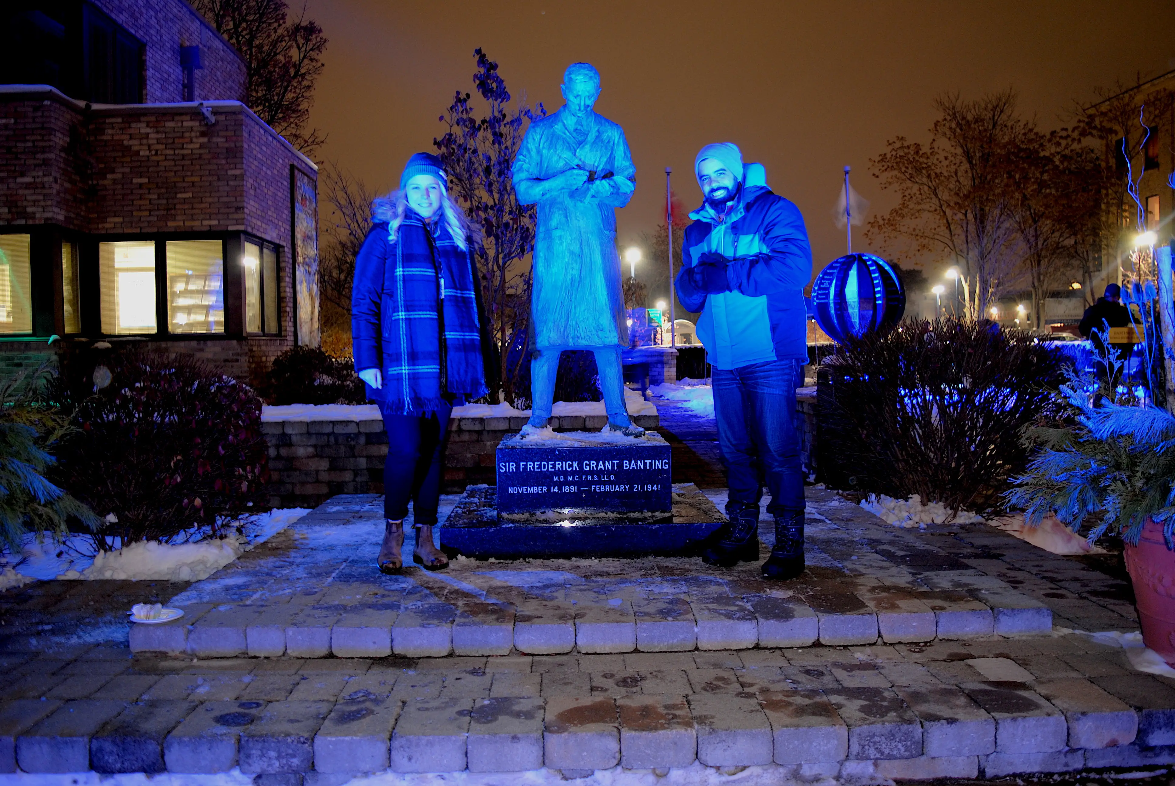 a group of people standing in front of a statue