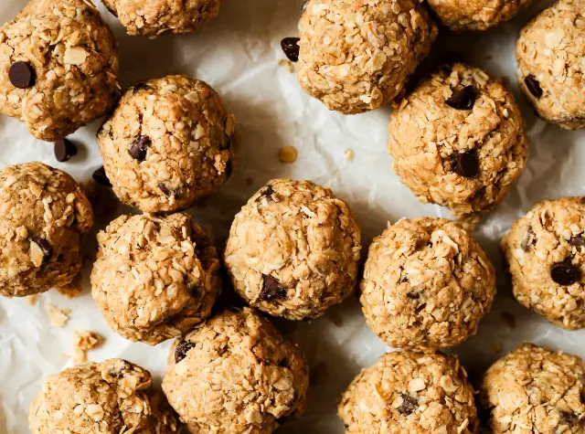 a group of round brown balls with chocolate chips