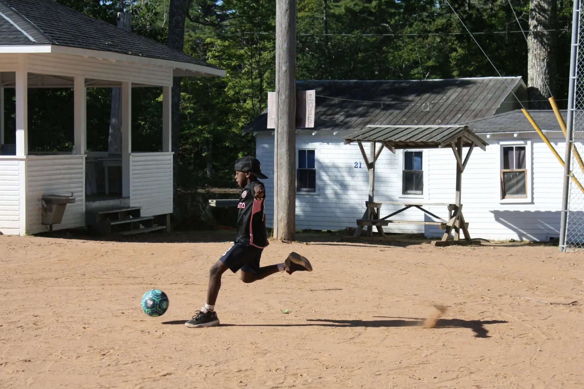 a boy kicking a football ball
