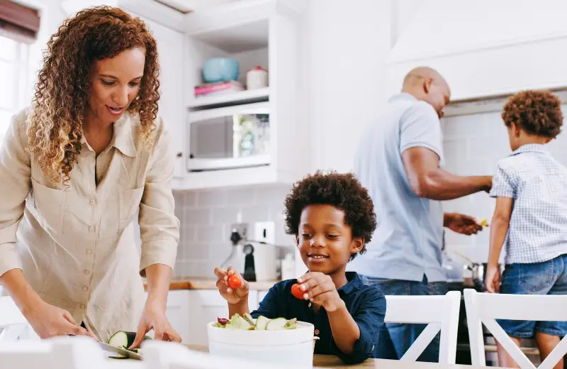 a woman and a boy in a kitchen