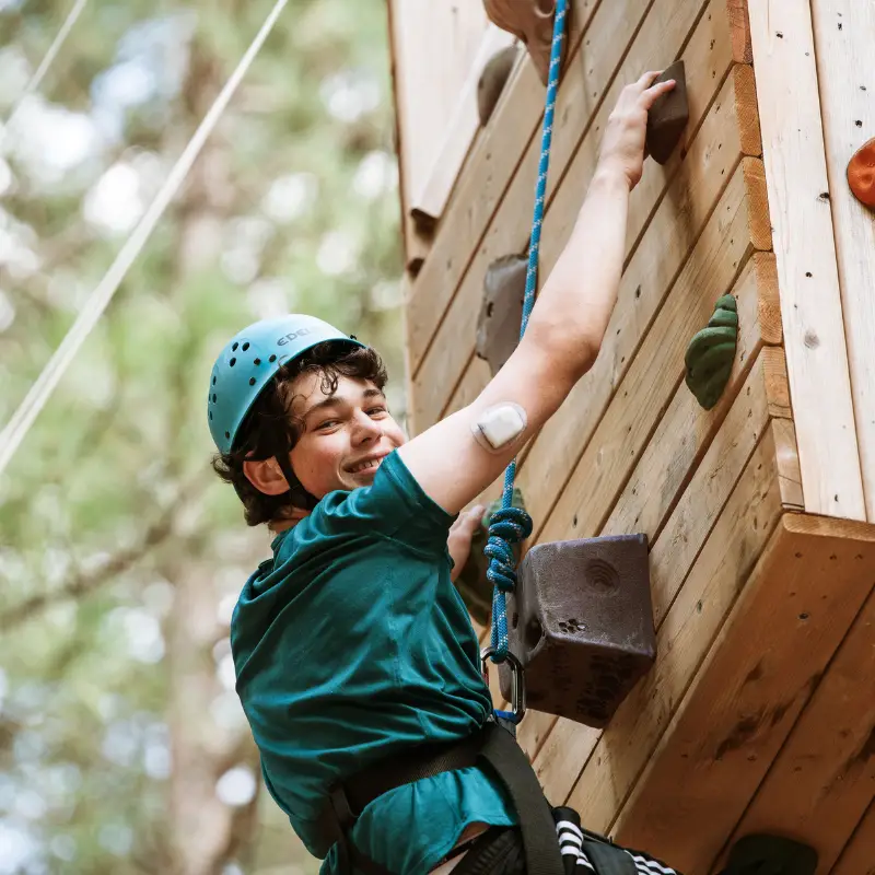 a boy climbing a wall