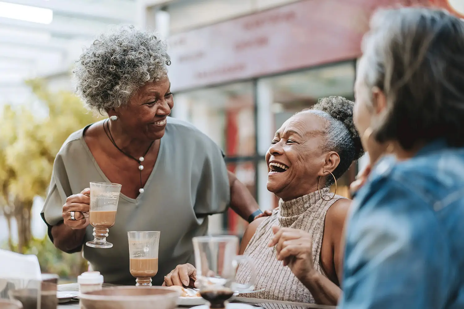 a group of women laughing at a table