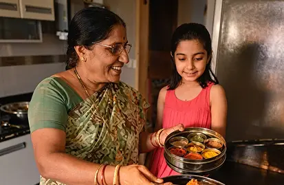 a woman and girl holding food