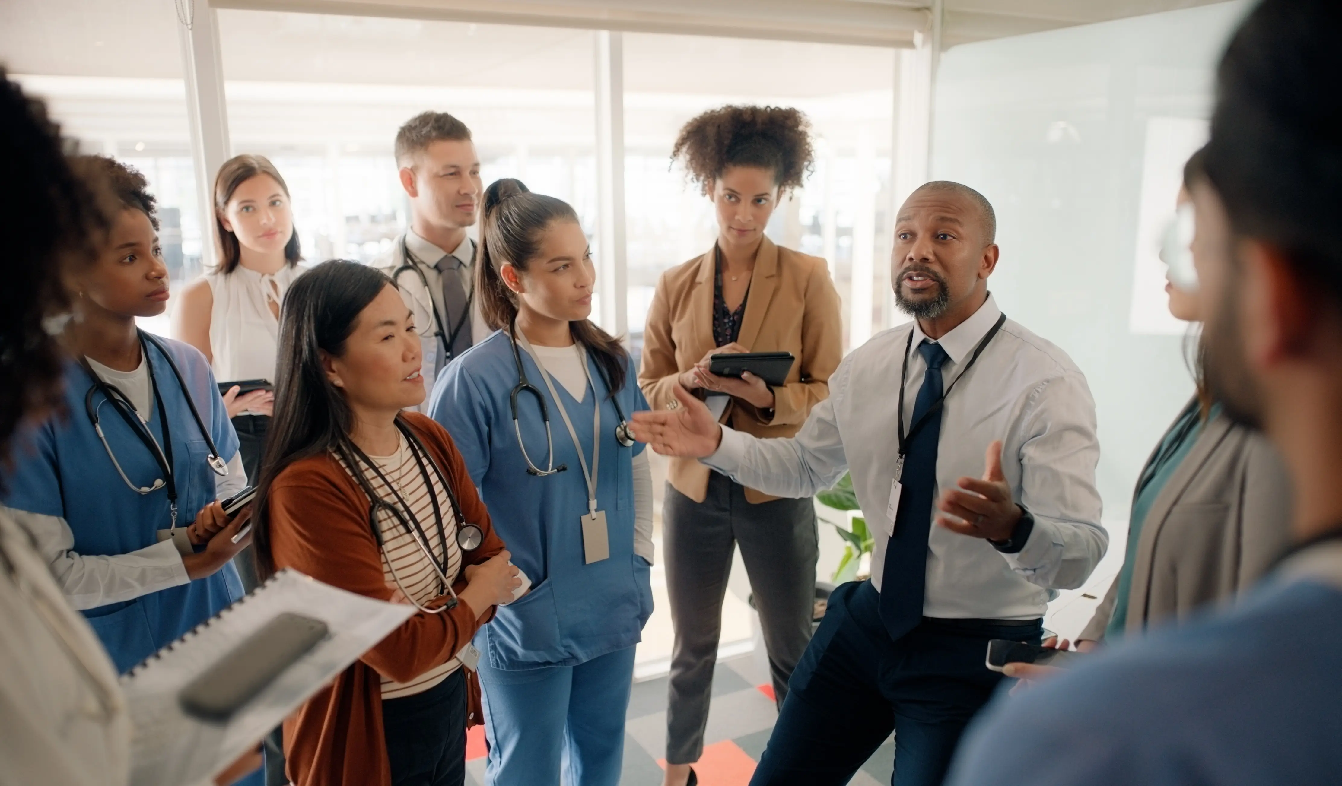 a group of people standing around each other