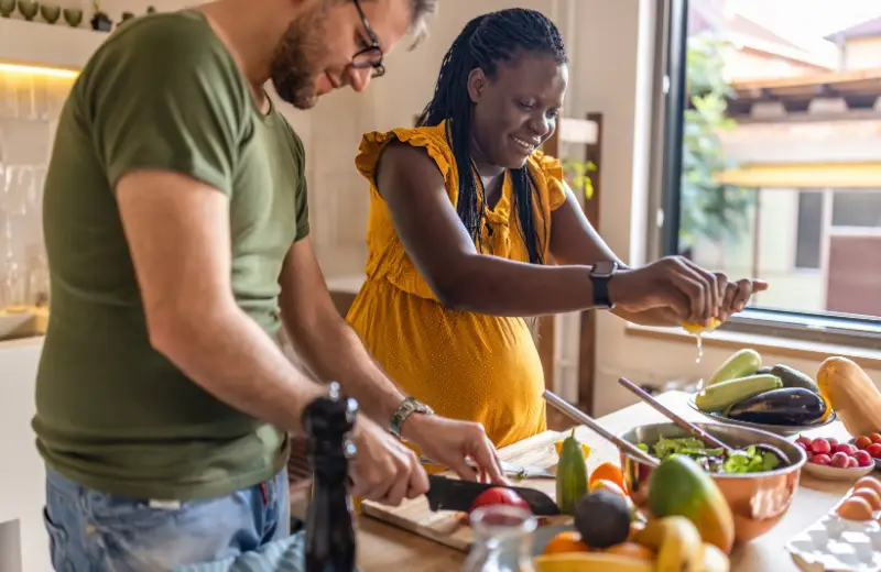 a man and woman cooking in a kitchen
