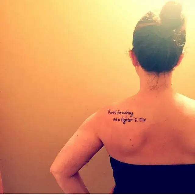 a woman with a tattoo on her back