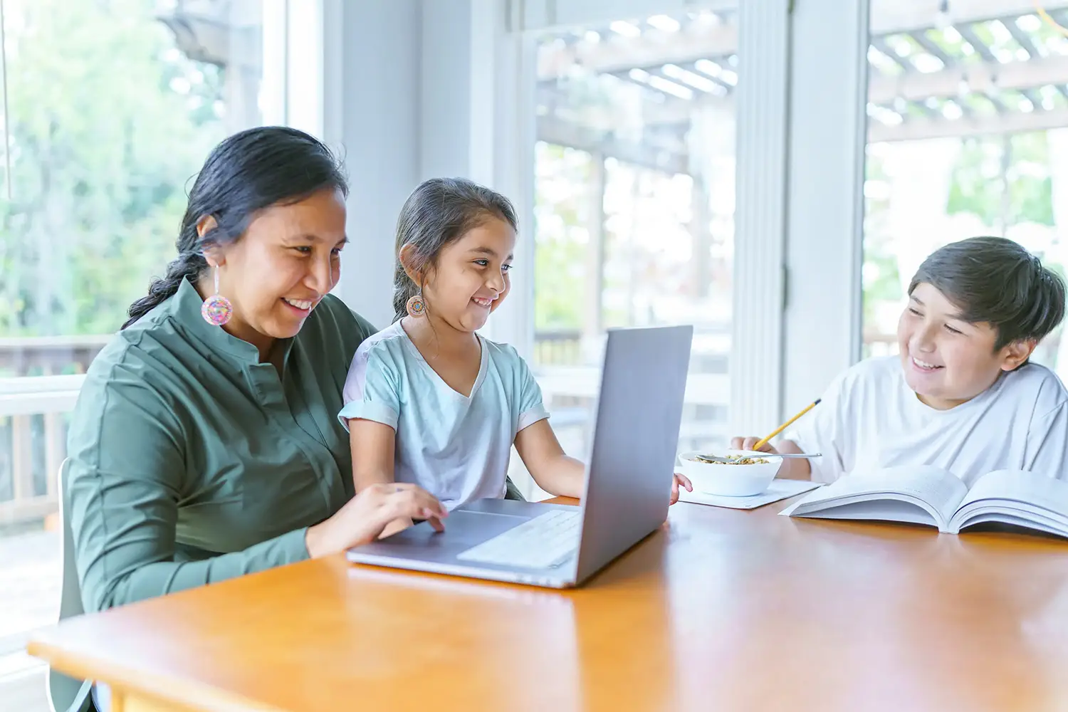 a woman and a girl looking at a laptop