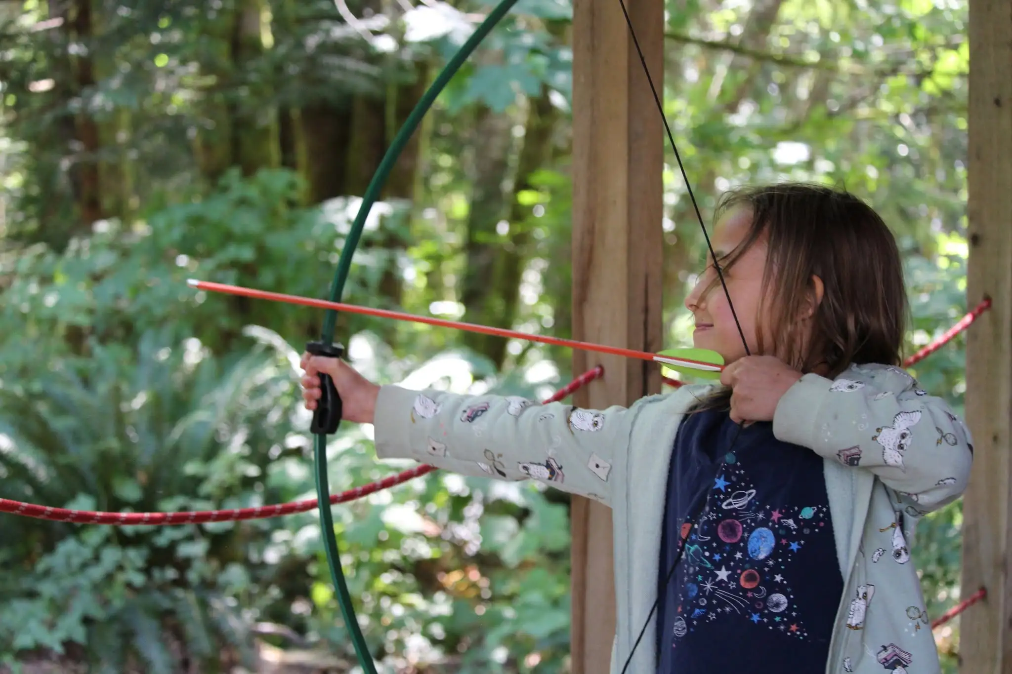 a girl holding a bow and arrow