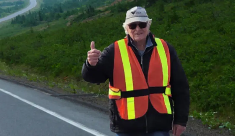 a man wearing a safety vest and sunglasses