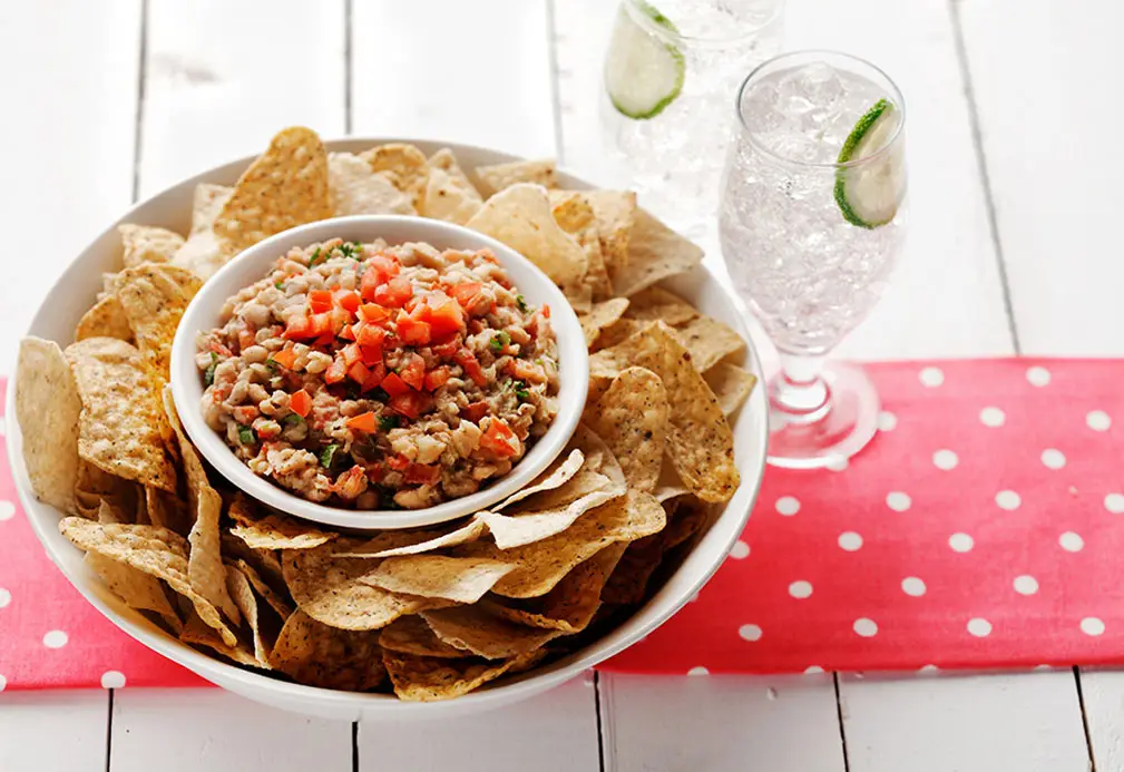 a bowl of food and two glasses of water