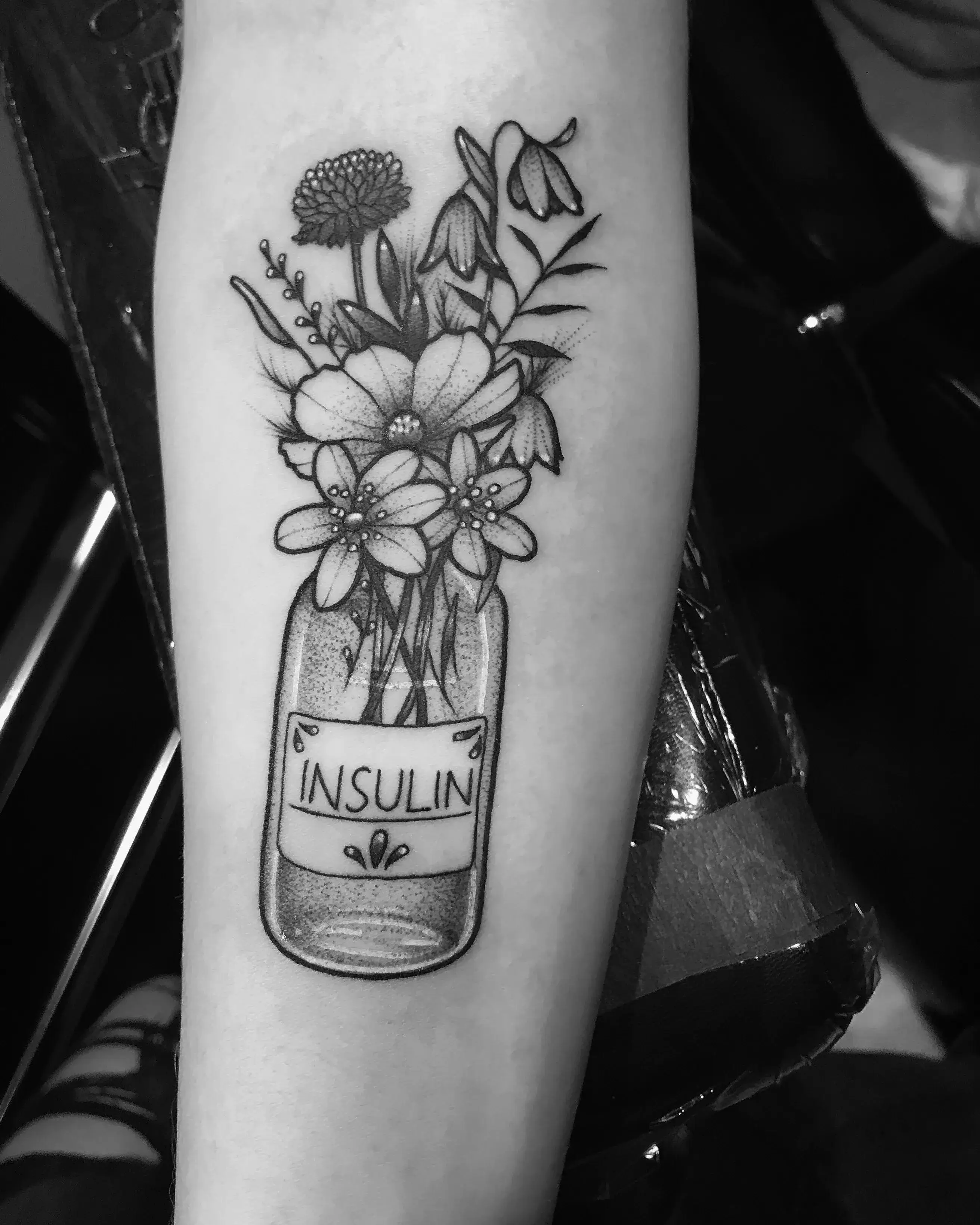a tattoo of flowers in a jar