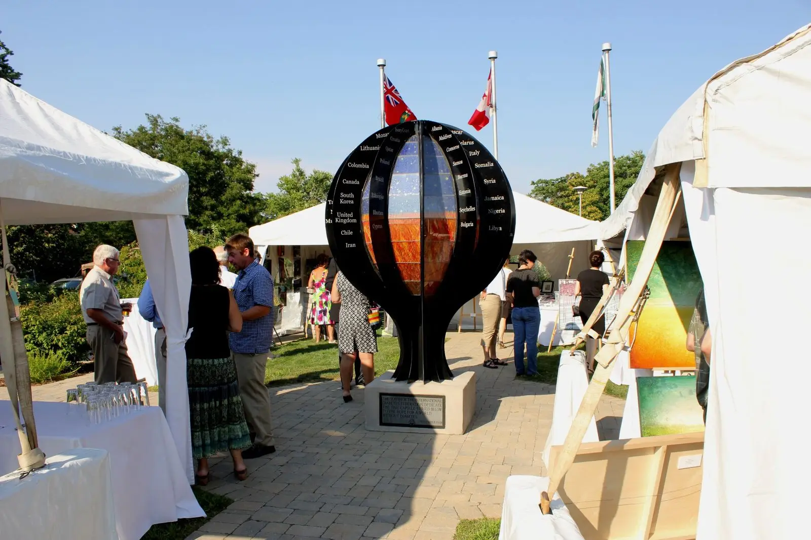 a group of people standing around a sculpture