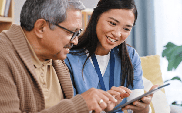 a man and a woman looking at a tablet